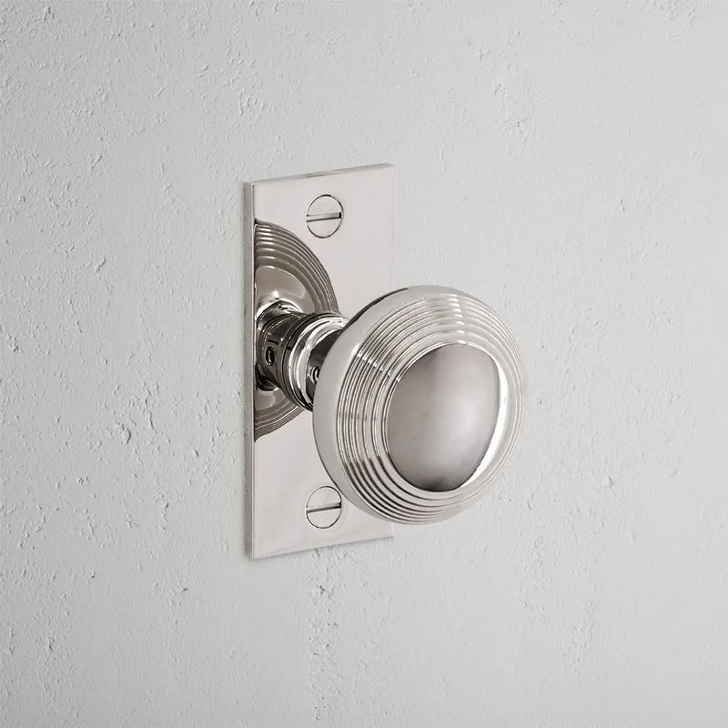 Poplar Short Plate Sprung Door Knob - Polished Nickel