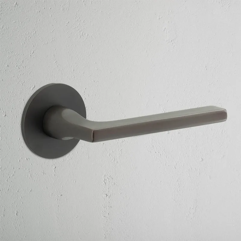 Clayton Sprung Door Handle With Flush Rose - Bronze